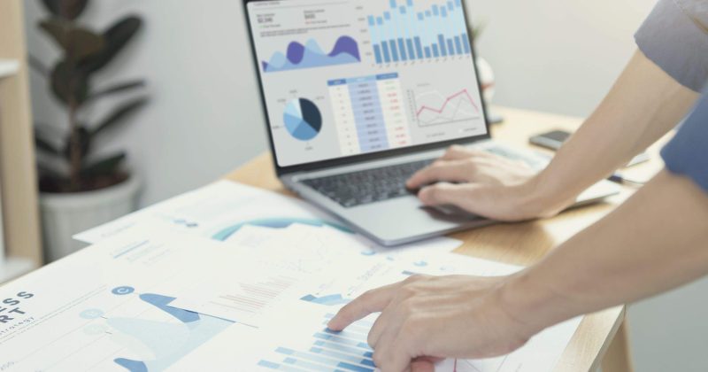 Businesspeople working in finance and accounting Analyze financial graph budget and planning for future in office room.